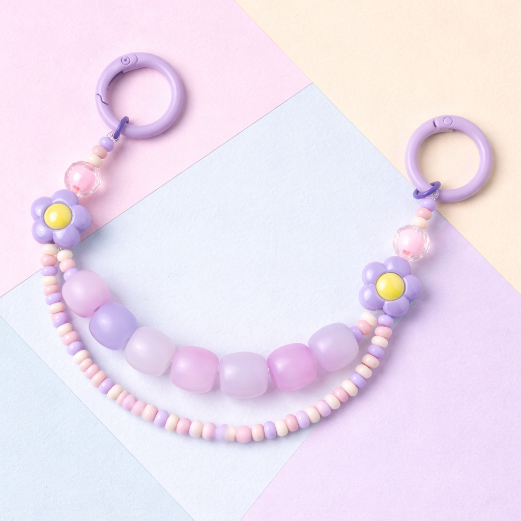 Pastel-colored beaded necklace with floral elements on a multicolored background